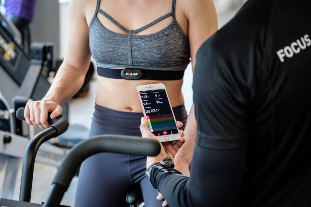 A personal trainer assessing heart health during a workout